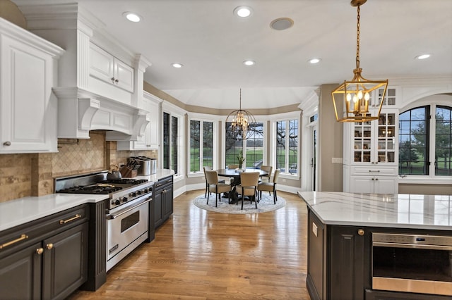 41W050 Stoneridge Ln, Elgin, IL 60124 - kitchen with luxury range, an inviting chandelier, recessed lighting, and white cabinets