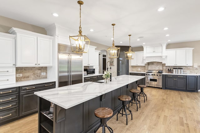 41W050 Stoneridge Ln, Elgin, IL 60124 - kitchen with white cabinetry, high end appliances, and backsplash