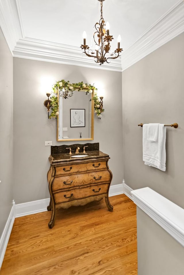 41W050 Stoneridge Ln, Elgin, IL 60124 - bathroom featuring an inviting chandelier, wood finished floors, baseboards, and crown molding