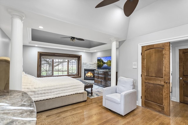 41W050 Stoneridge Ln, Elgin, IL 60124 - bedroom featuring a raised ceiling, wood finished floors, a stone fireplace, and decorative columns