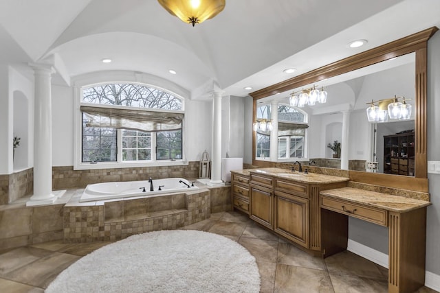 41W050 Stoneridge Ln, Elgin, IL 60124 - full bath featuring lofted ceiling, an inviting chandelier, decorative columns, a garden tub, and vanity