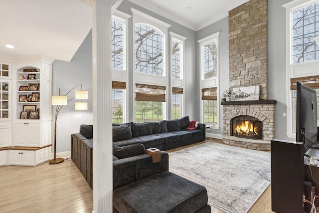 41W050 Stoneridge Ln, Elgin, IL 60124 - living area with a towering ceiling, light wood-style flooring, baseboards, and a stone fireplace
