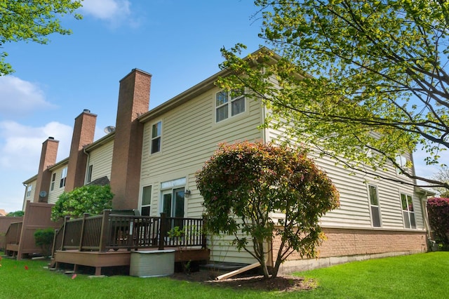 716 Samson Way, Northbrook, IL 60062 - back of property featuring a wooden deck, a lawn, and a chimney