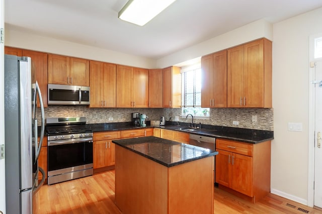 716 Samson Way, Northbrook, IL 60062 - kitchen featuring appliances with stainless steel finishes, light wood-type flooring, backsplash, and dark stone countertops