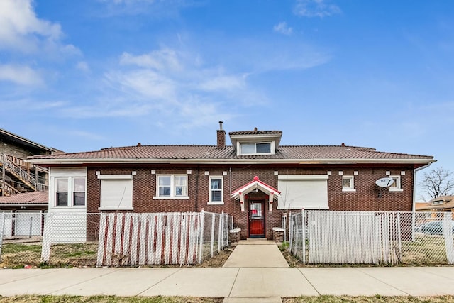 7658 S Laflin St, Chicago, IL 60620 - view of front of house featuring brick siding, a chimney, and a fenced front yard