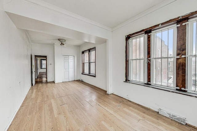 7658 S Laflin St, Chicago, IL 60620 - empty room featuring crown molding, visible vents, ceiling fan, and light wood finished floors