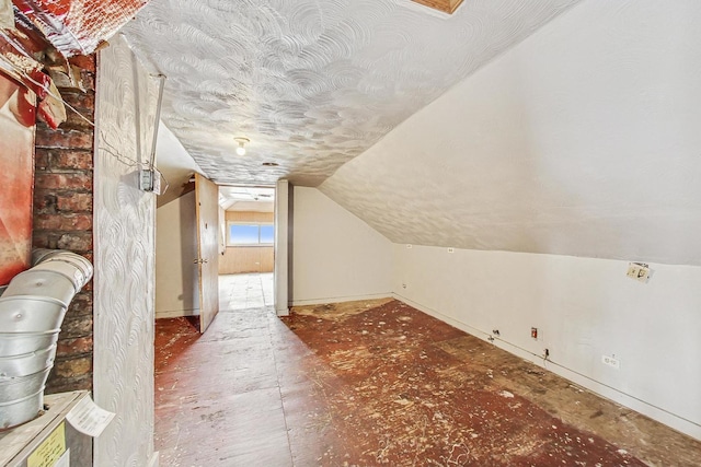 7658 S Laflin St, Chicago, IL 60620 - bonus room featuring baseboards, vaulted ceiling, and a textured ceiling