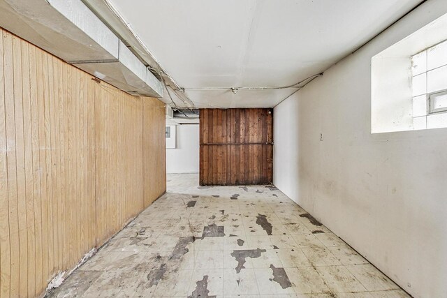 7658 S Laflin St, Chicago, IL 60620 - below grade area with tile patterned floors and wood walls
