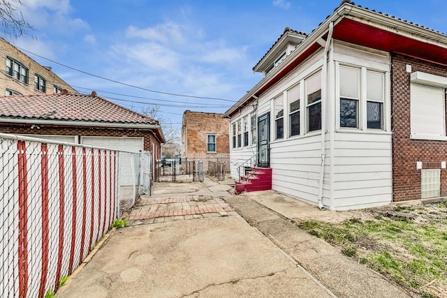 7658 S Laflin St, Chicago, IL 60620 - view of home's exterior with brick siding, entry steps, and fence