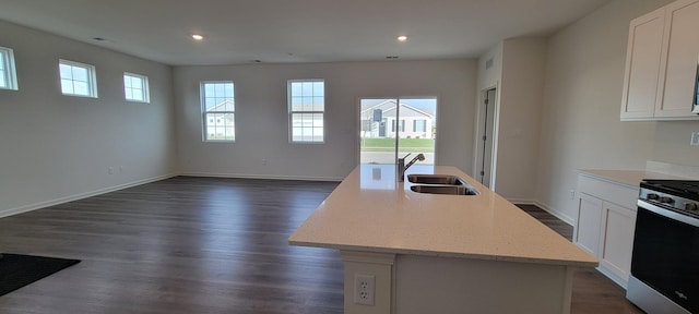 6457 Juniper Dr, Wonder Lake, IL 60097 - kitchen featuring open floor plan, white cabinetry, a center island with sink, range with gas cooktop, and a sink