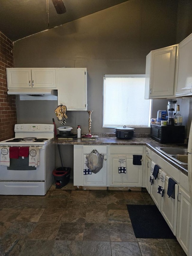 kitchen with white cabinetry, white electric range, and brick wall