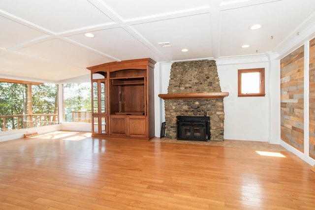 unfurnished living room featuring recessed lighting, light wood-type flooring, a stone fireplace, and coffered ceiling