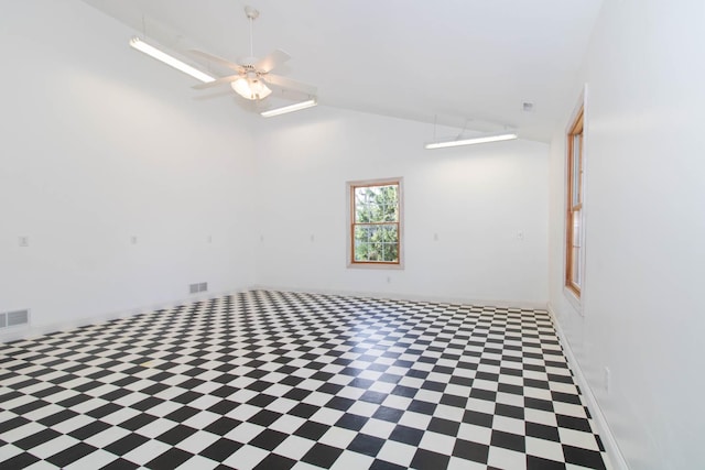 spare room with visible vents, a ceiling fan, baseboards, and high vaulted ceiling