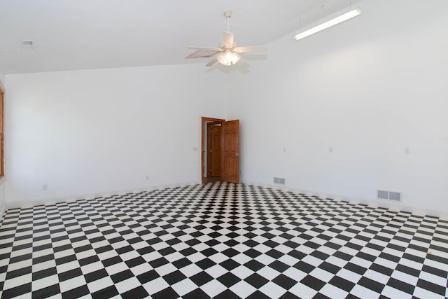 spare room with baseboards, a ceiling fan, visible vents, and high vaulted ceiling