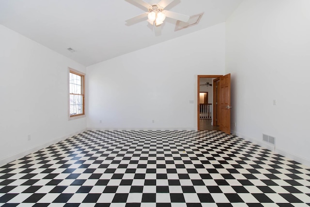 empty room with baseboards, visible vents, high vaulted ceiling, and ceiling fan