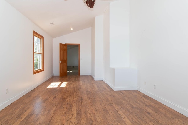 unfurnished room with vaulted ceiling, a ceiling fan, baseboards, and wood finished floors