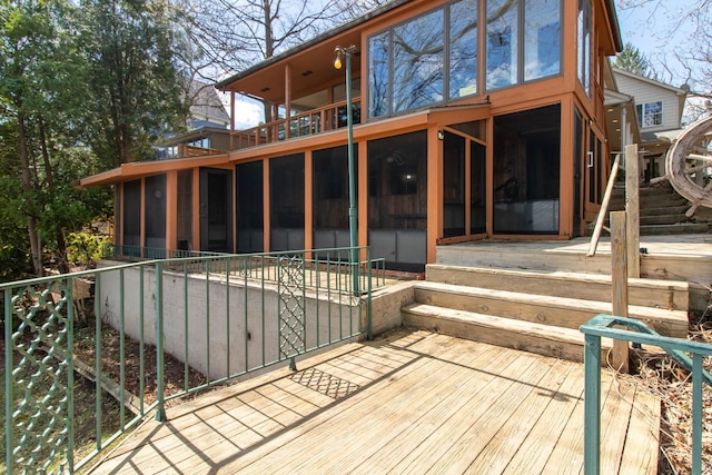back of house featuring a sunroom