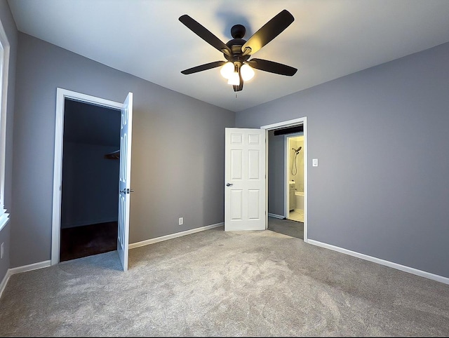 unfurnished bedroom featuring carpet floors, baseboards, a ceiling fan, and a closet