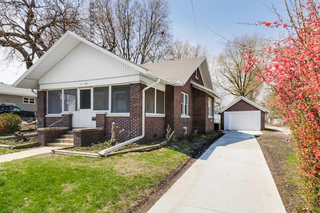 bungalow-style home with an outdoor structure, a detached garage, driveway, brick siding, and a sunroom