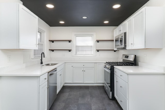 kitchen with white cabinetry, appliances with stainless steel finishes, a sink, and open shelves
