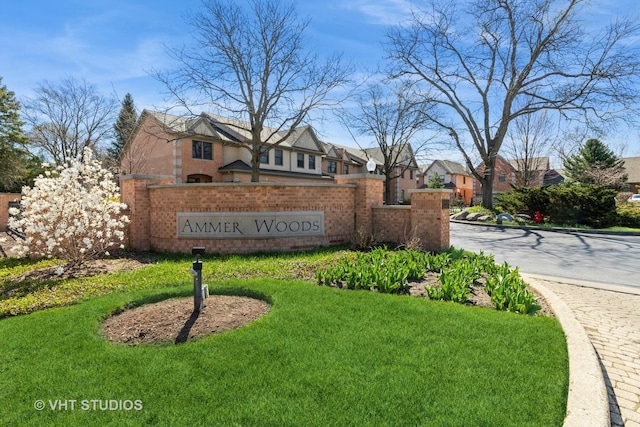community / neighborhood sign featuring a yard and a residential view