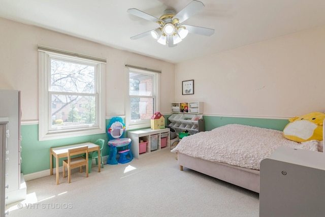 bedroom with ceiling fan, baseboards, and carpet floors