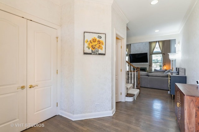 hallway with recessed lighting, baseboards, ornamental molding, and dark wood finished floors