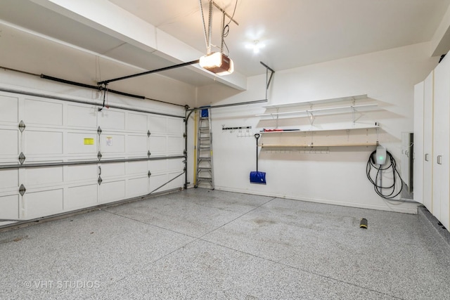 garage featuring a garage door opener and baseboards