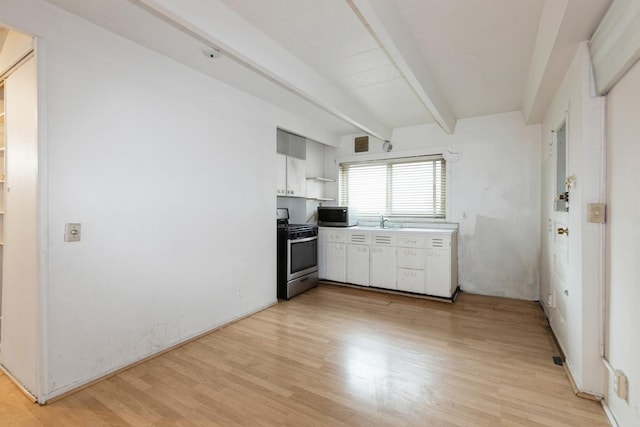 kitchen with visible vents, light countertops, light wood-type flooring, beamed ceiling, and stainless steel appliances