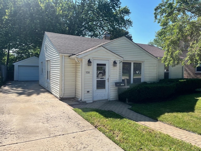 158 N Pershing Ave, Mundelein, IL 60060 - bungalow-style home with an outdoor structure, a shingled roof, a garage, a chimney, and a front yard