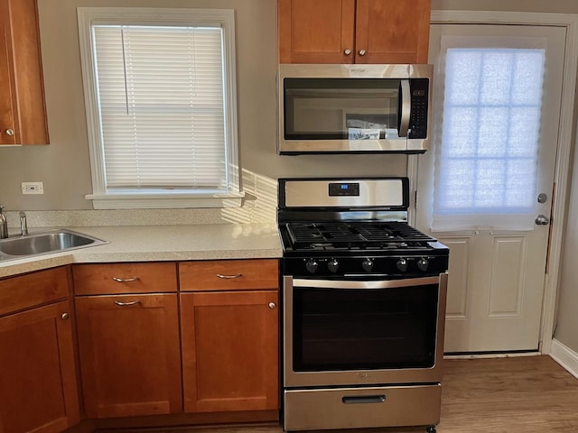 158 N Pershing Ave, Mundelein, IL 60060 - kitchen featuring stainless steel appliances, brown cabinetry, light countertops, and wood finished floors