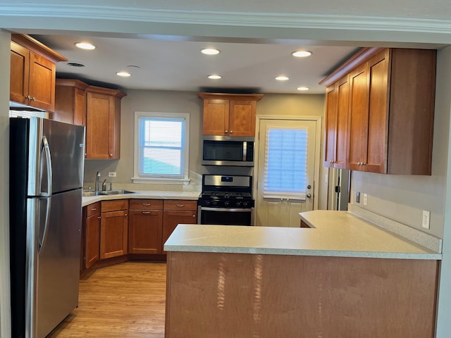 158 N Pershing Ave, Mundelein, IL 60060 - kitchen with stainless steel appliances, a peninsula, light wood-type flooring, recessed lighting, and brown cabinets