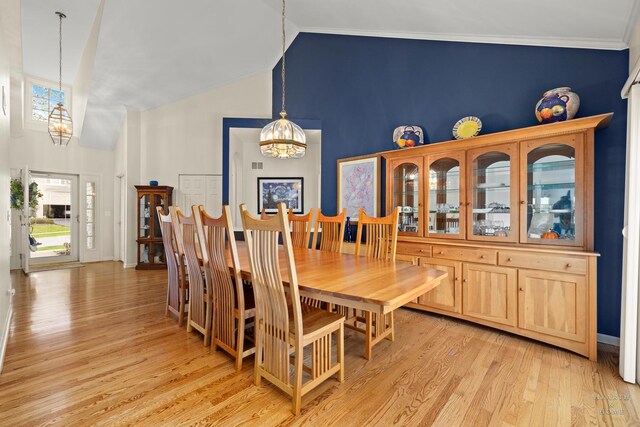 803 Pleasant Dr, Fox River Grove, IL 60021 - dining space with a chandelier, light wood-style floors, baseboards, ornamental molding, and high vaulted ceiling
