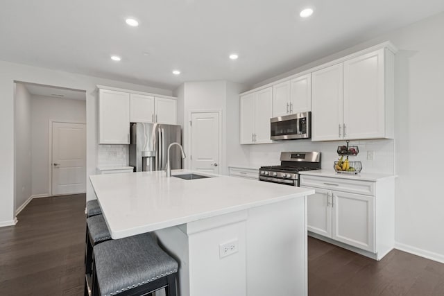 2830 Kessler Dr, Mundelein, IL 60060 - kitchen with appliances with stainless steel finishes, a sink, baseboards, dark wood-style floors, and decorative backsplash
