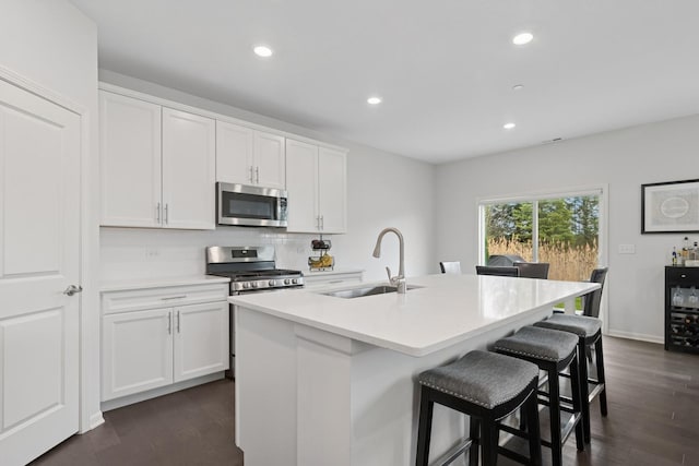 2830 Kessler Dr, Mundelein, IL 60060 - kitchen featuring appliances with stainless steel finishes, a sink, backsplash, recessed lighting, and white cabinetry