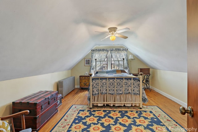 36603 N Iola Ave, Ingleside, IL 60041 - bedroom with radiator heating unit, vaulted ceiling, baseboards, and wood finished floors