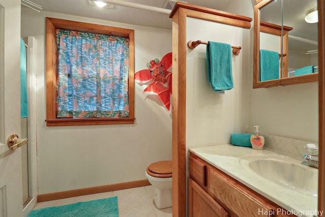 36603 N Iola Ave, Ingleside, IL 60041 - full bathroom with tile patterned floors, a shower with door, toilet, vanity, and baseboards