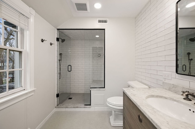 195 Lakeside Pl, Highland Park, IL 60035 - bathroom with visible vents, toilet, a shower stall, and tile patterned flooring