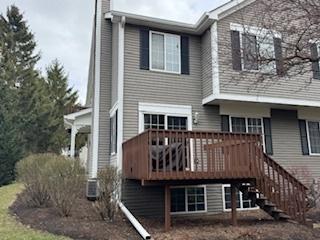 1314 Sandhurst Ln Unit 1314, South Elgin, IL 60177 - rear view of property featuring a wooden deck and a chimney