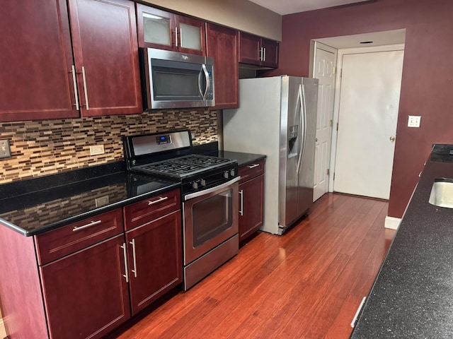 1314 Sandhurst Ln Unit 1314, South Elgin, IL 60177 - kitchen with stainless steel appliances, reddish brown cabinets, tasteful backsplash, and wood finished floors