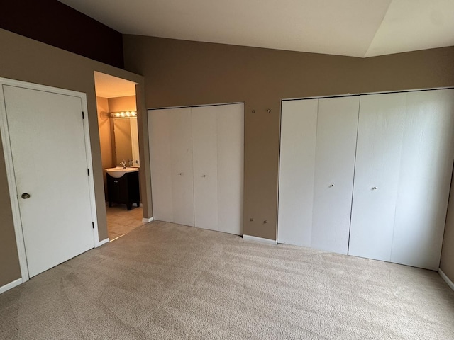 1314 Sandhurst Ln Unit 1314, South Elgin, IL 60177 - unfurnished bedroom with multiple closets, carpet, a sink, connected bathroom, and vaulted ceiling