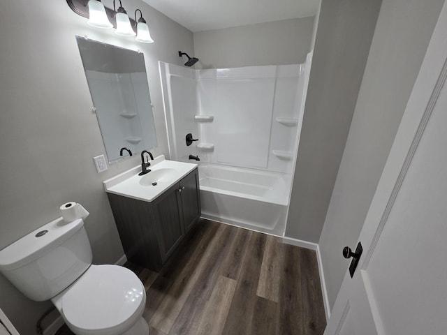 full bathroom with toilet, vanity, wood finished floors, and tub / shower combination