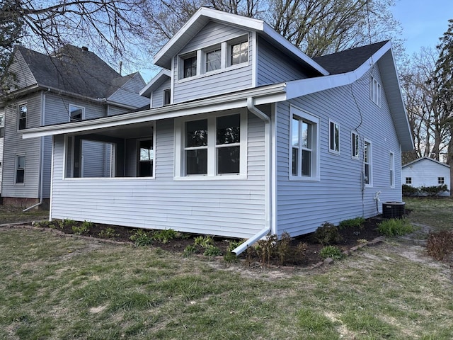 view of property exterior featuring central AC unit and a lawn