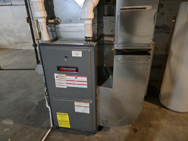 utility room with water heater and heating unit