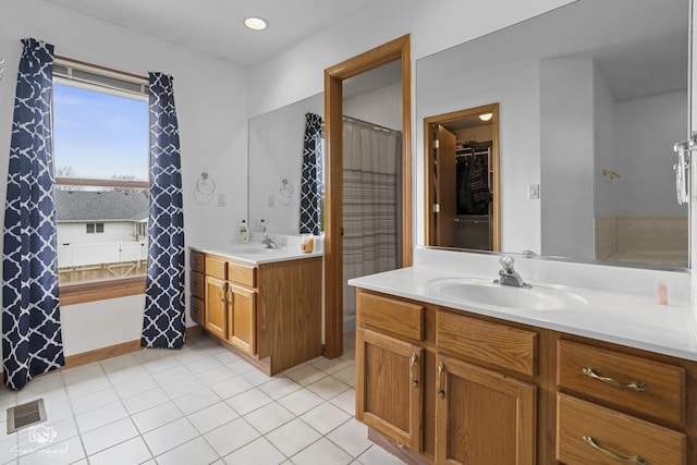 full bathroom featuring two vanities, visible vents, recessed lighting, a sink, and tile patterned floors