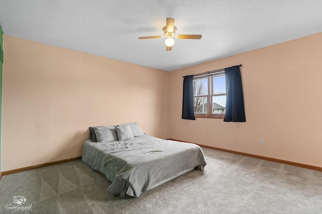 carpeted bedroom featuring ceiling fan and baseboards