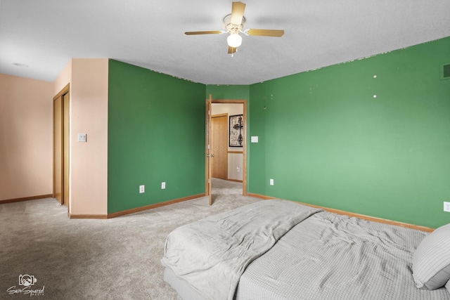 carpeted bedroom featuring visible vents, baseboards, and ceiling fan