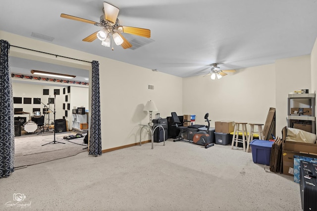 interior space featuring speckled floor, ceiling fan, baseboards, and visible vents