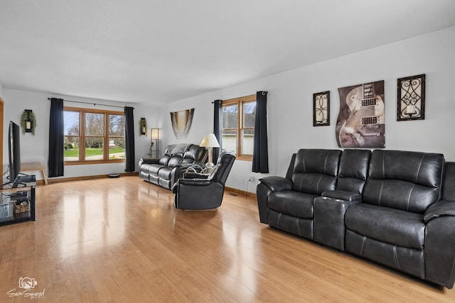 living room with light wood finished floors and baseboards