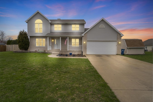 traditional-style house with brick siding, an attached garage, a lawn, and driveway
